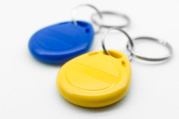 RFID tag key chain. Plastic cloned non-contact electronic radio key for intercom. NFC tag. Ukrain flag colors. Selective focus