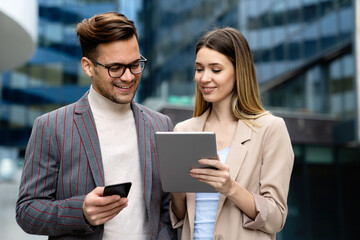 Two desingers, business people working on a project together in urban background
