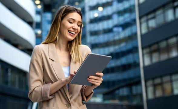 Portrait of successful woman using digital tablet in urban background. Business people concept