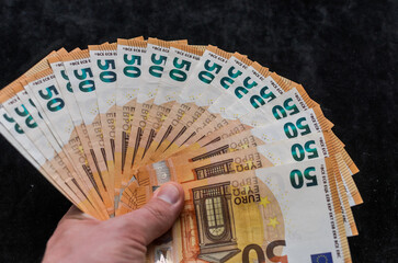A man counts money - euro banknotes with a face value of 50 euros	

