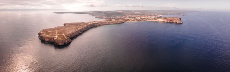 Panoramic aerial view of Sagres fortress (Fortaleza de Sagres) and the lighthouse on the cliff facing the Atlantic Ocean, Sagres, Algarve region, Portugal.