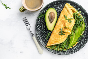 Omelet and Salad with green vegetables avocado and arugula, Delicious vegan, vegetarian breakfast