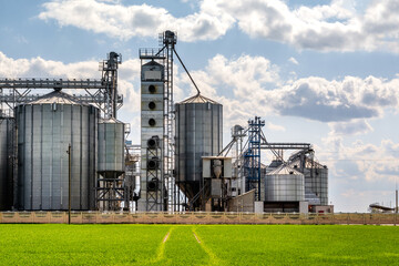 panorama view on agro silos granary elevator on agro-processing manufacturing plant for processing drying cleaning and storage of agricultural products, flour, cereals and grain. © hiv360