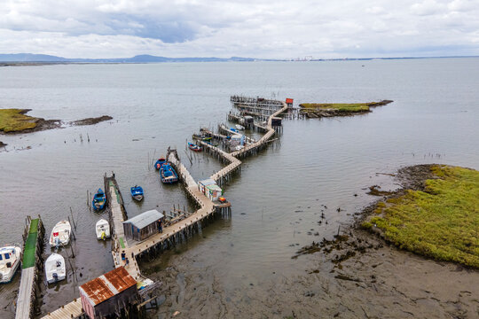 Aerial view of Porto Palafita da Carrasqueira, a beautiful pier made of wood by fishermen renowned for its sunset view, Comporta, Troia Peninsula, Setubal, Portugal.