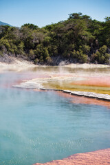 Steaming hot vulcanic lake in Rotoroa, New Zealand, North Island, with colorful, orange and yellow,...