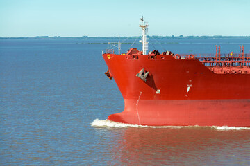 Front view of bow of large tanker cargo ship. Performing cargo export and import operation.