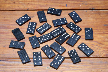 Black dominos on grungy wooden table