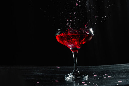 Splashing red wine in wineglass