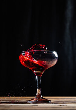 Splashing red wine in wineglass