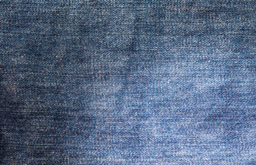 Naklejka premium Jeans,Blue jean fabric texture background,Classic Jeans Texture of blue jeans textile close up. Blue color of denim texture with copy space for advertise or vintage background.