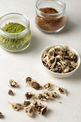 Pile of Moringa seed and moringa flower with leaf isolated on white background. The dried seeds in the pod are ready for propagate. Natural herbs can be extracted into oil for healthcare.