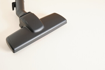 Head of modern vacuum cleaner on beige background. Close up.