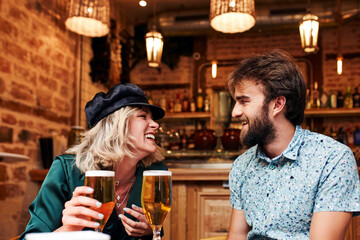 Caucasian couple having a drink at a bar.