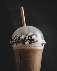 Close-up shot of a dark chocolate frappe on a black background
