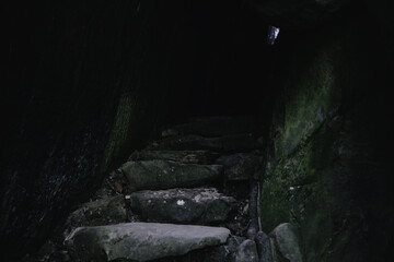 Closeup of the stone stair of a cave in darkness