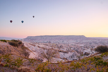 Fototapeta na wymiar Travel and tourism by Turkey. Famous sightseeing Cappadocia, Anatolia. Beautiful landscape with mountains, caves and baloons in the sky.