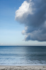 Naklejka na ściany i meble Beautiful cloud formation over the blue sea