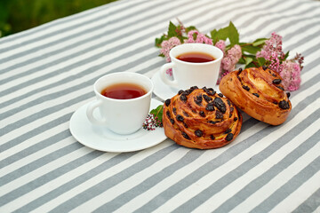 Sweet bun with glass of black tea on the table. white and green background. concept composition breakfast