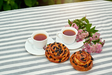 Sweet bun with glass of black tea on the table. white and green background. concept composition breakfast