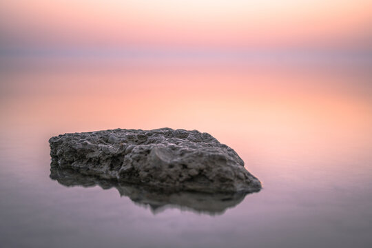 View of the big stone in the water at the sunset