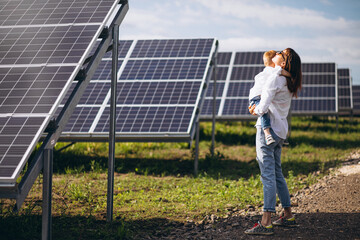 Mother with her little son by solar panels