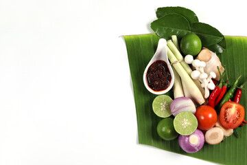 Tom Yum spices ingredients, Thai food, Thai soup on white background, lemongrass, galangal, lime, shallots, fresh chili, kaffir lime leaves, mushrooms, parsley, tomatoes, top view have copy space.