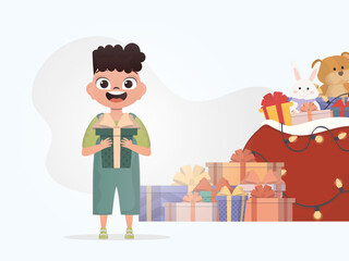 A smiling preschool boy stands and holds a gift box in his hands. Christmas. Cartoon style.
