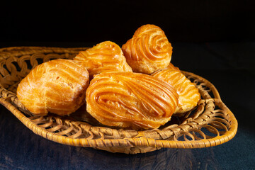 Sweet eclairs in a plate on the table