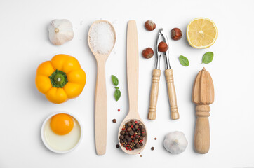 Composition with cooking utensils and fresh ingredients on white background, top view