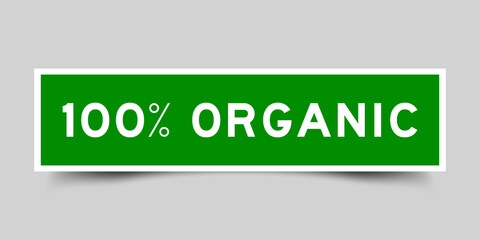 Sticker label with word 100 percent organic in green color on gray background