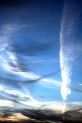 White Clouds and Flight Lines in a Blue Sky with Fog