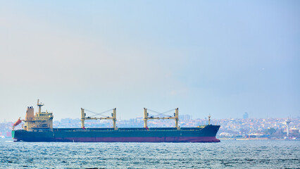 Fototapeta premium An bulk carrier or bulker sails in the sea to trade around the world