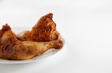 Grilled chicken is on the plate. On a white background. Copy space.