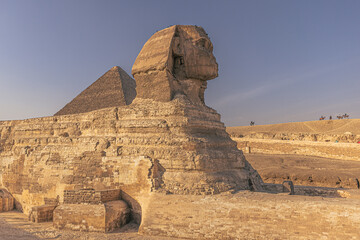 Fototapeta na wymiar Giza, Egypt - November 14, 2021: The Great Sphinx by the great ancient Pyramids of Giza, Egypt