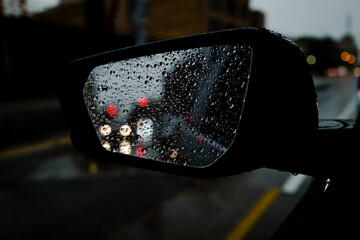 Closeup shot of the side mirror of a car with raindrops - Powered by Adobe