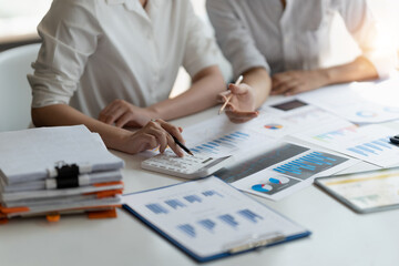Close up accountant bookkeeper woman working about financial with calculator at his office to calculate expenses, Accounting concept