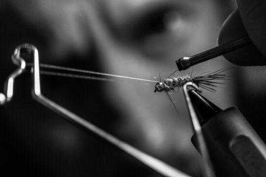 Close-up shot of an angler tying a homemade fly