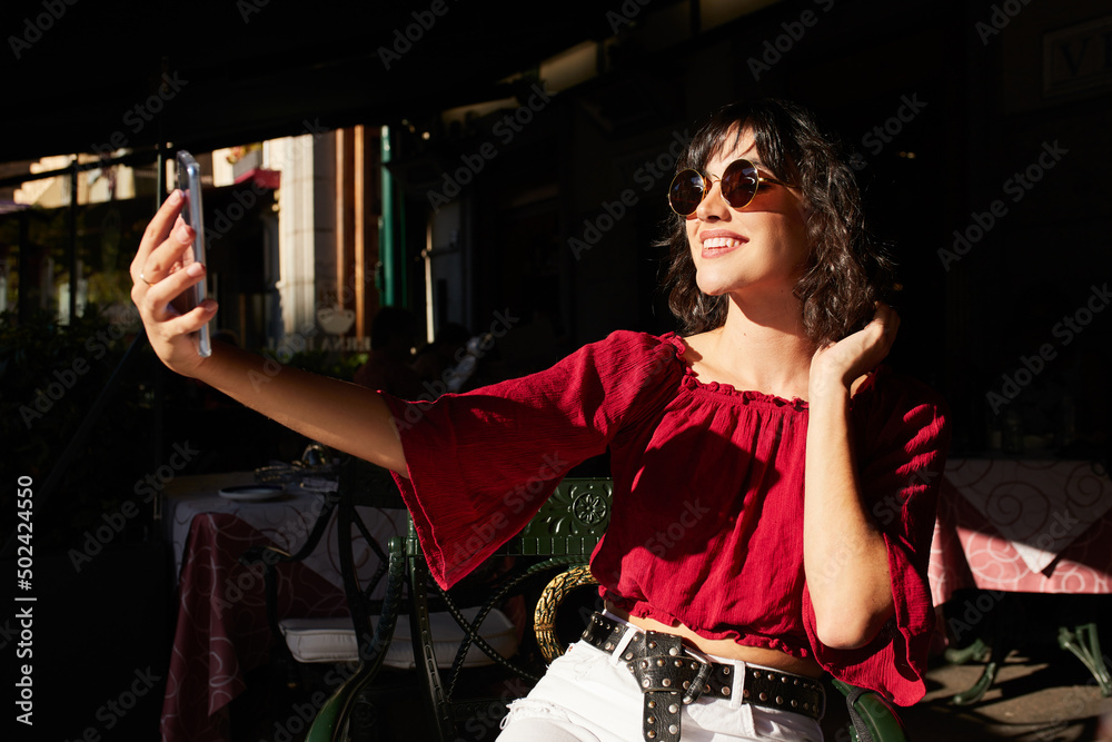 Wall mural teenager girl taking a selfie.