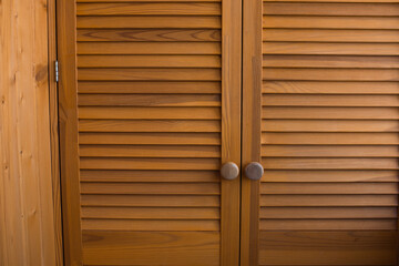 Front showcase cabinet or wardrobe wooden frame door and drawers made from dark wood, background and texture, interior design