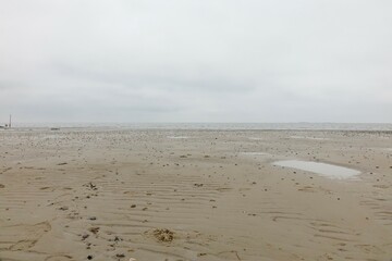 Sandy North Sea beach at low tide, cloudy spring day (horizontal), Sahlenburg, Lower Saxony, Germany