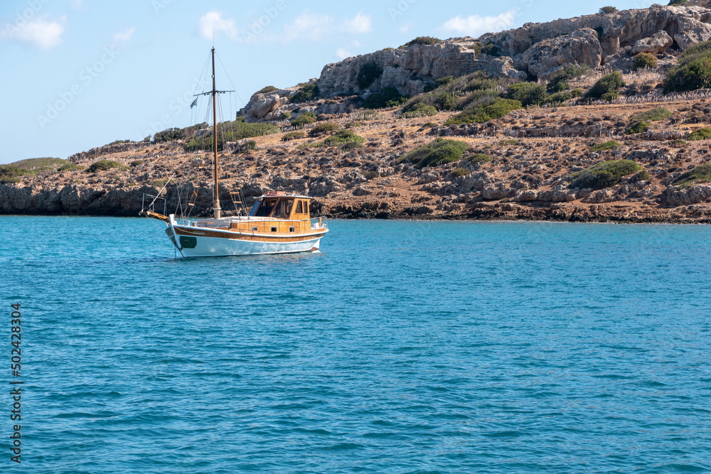 Canvas Prints Beautiful shot of a small yellow boat on  a blue lake with a mountain background