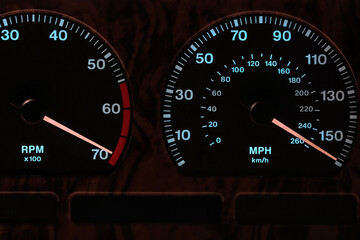 tachometer and speedometer in car dashboard at full power in illuminated night mode