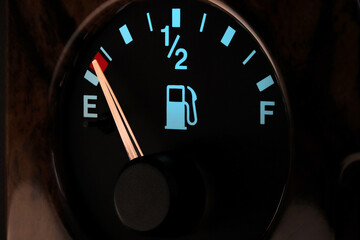 fuel gauge in car dashboard in illuminated night mode  - empty