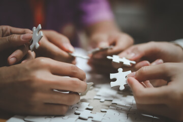 business strategy ideas Business team planning a strategic meeting Assembling jigsaw pieces, using jigsaw puzzles, showing solutions for business people, teamwork. 