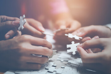 business strategy ideas Business team planning a strategic meeting Assembling jigsaw pieces, using jigsaw puzzles, showing solutions for business people, teamwork.
