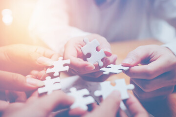 business strategy ideas Business team planning a strategic meeting Assembling jigsaw pieces, using...