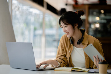 Beautiful Asian woman using a laptop to study online, she is studying online. The concept of online learning due to the COVID-19 outbreak to prevent an outbreak in the classroom.