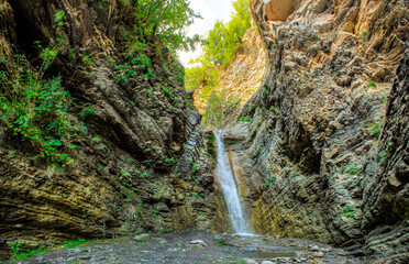 A beautiful waterfall in a mountain gorge.
