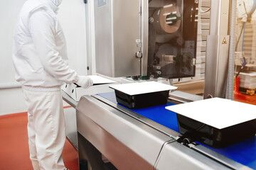 People working.Chicken fillet production line.Production process, packaging on the conveyor line of meat in boxes.Conveyor Belt Food.Automated production line in modern food factory.