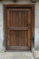 A small old solid wood door
